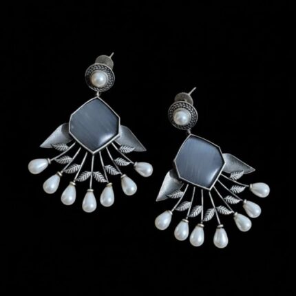 Oxidized Grey Stone Pearl Dangler Earrings resting on pure black background