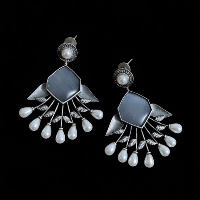 Oxidized Grey Stone Pearl Dangler Earrings resting on pure black background