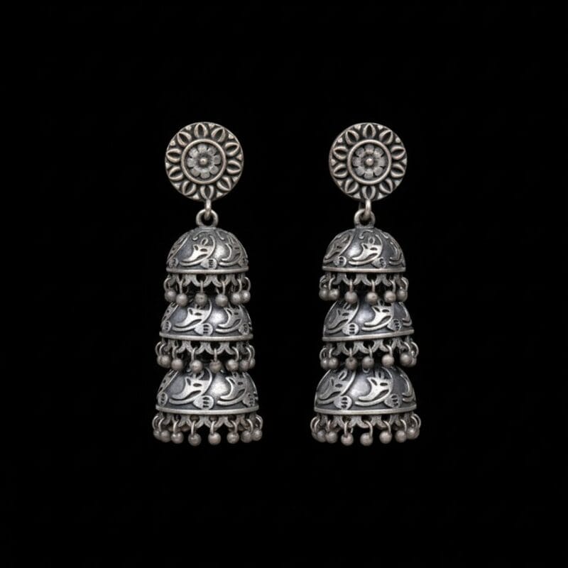 Three Tier Oxidized Jhumka Earrings on Plain Black Background