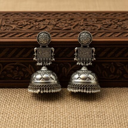 Traditional Oxidized Jhumka Earrings with Pearls placed over wooden box