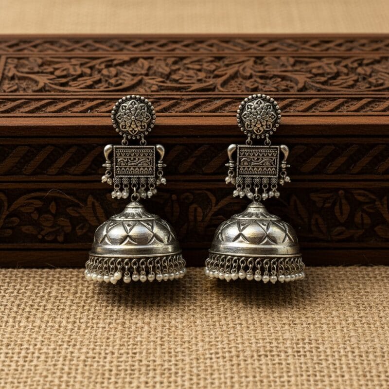 Traditional Oxidized Jhumka Earrings with Pearls placed over wooden box