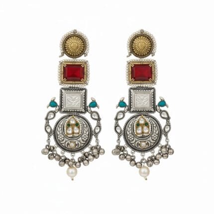 A pair of long traditional silver look earrings with square red Kundan stones, small pearls, teal accents, and silver ghungroos on a white background.
