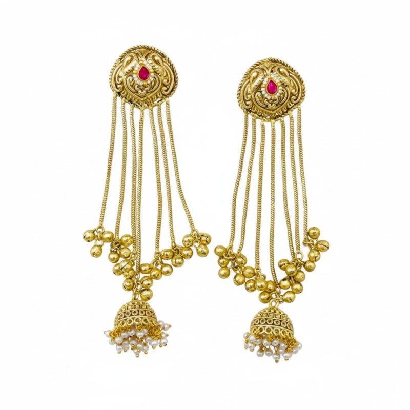 A pair of ornate golden jhumka chain earrings with a pink stone and white pearls on a white background