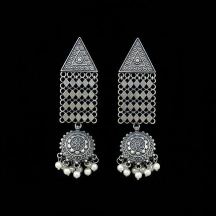 Pair of oxidized silver look triangle jhumka earrings with white pearl drops on a black background
