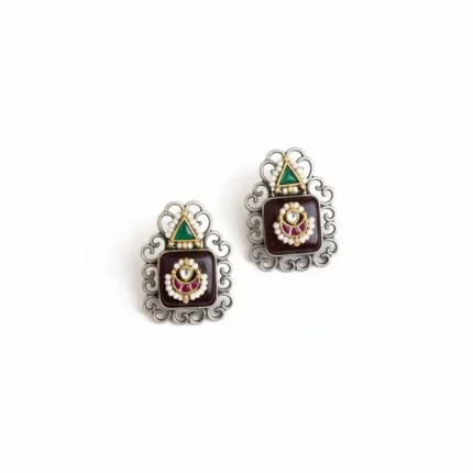 Two pairs of traditional brass Monalisha stone stud earrings. Pair has black stones it intricate silver frames and pearl accents.