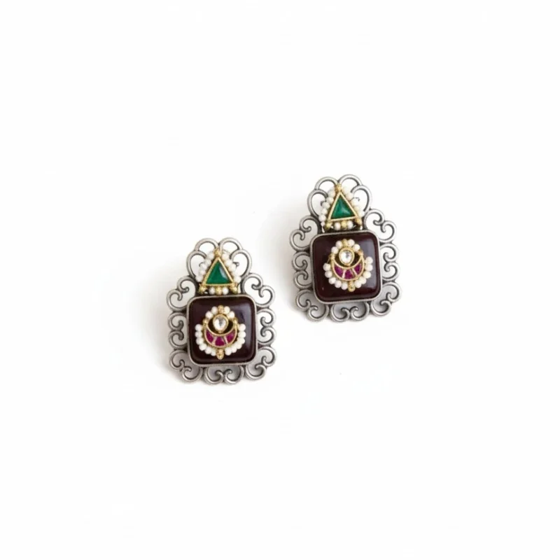 Two pairs of traditional brass Monalisha stone stud earrings. Pair has black stones it intricate silver frames and pearl accents.