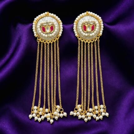 Traditional Lotus Pearl Dangle Earrings placed on blueish purple silk cloth