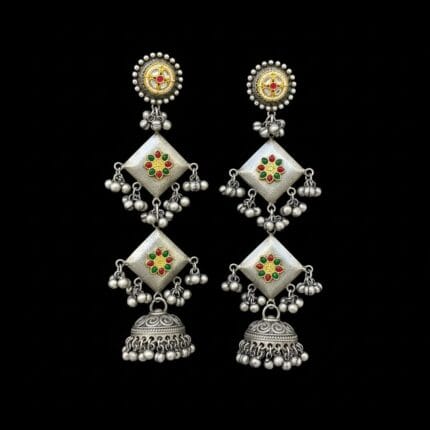 A pair of long traditional oxidized silver look jhumka earrings featuring square elements with red, green, and yellow artificial stones placed on black bg