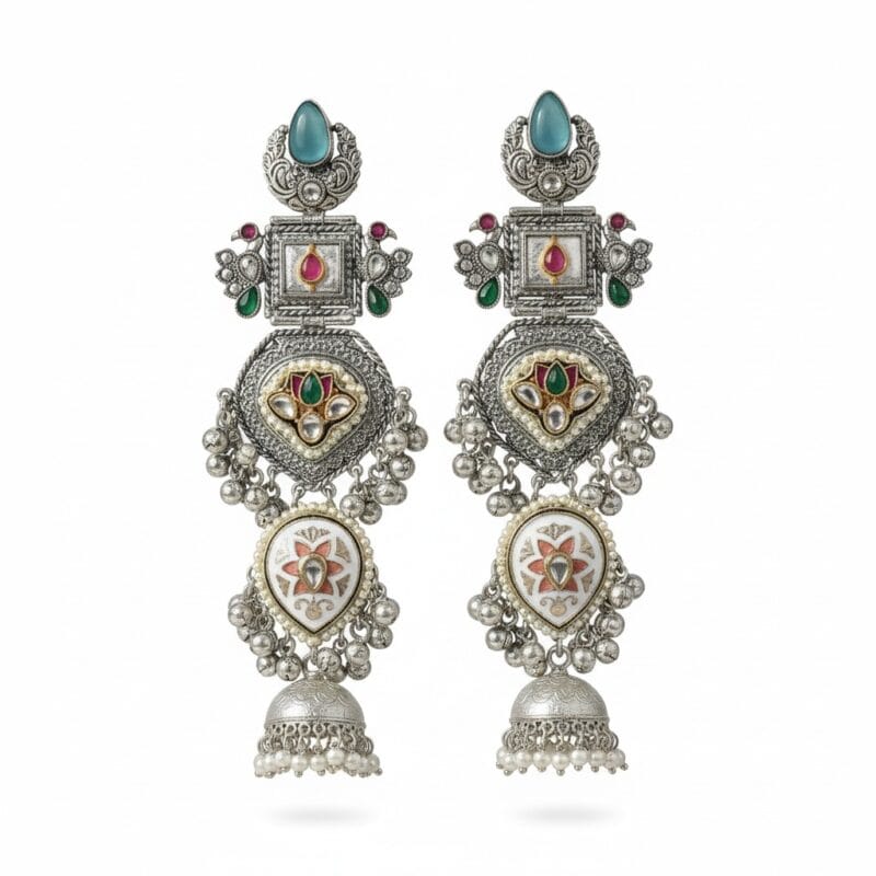 a pair of long silver plated traditional Kundan Chandbali Jhumka earrings with blue, pink, and green artificial stones placed on a plain white background