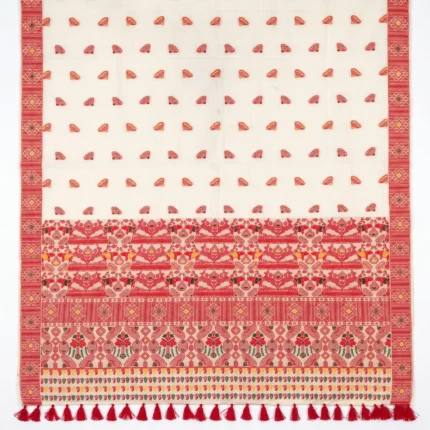 Assamese cream coloured saree with woven floral designs in red and yellow with large red tassels on border.