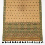 Full View of beige bamboo cotton saree with green woven border and dark green tassels.