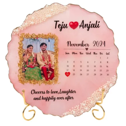 Wedding photo, calendar for November 2024, clusters of white pearls on gold stand, round pink resin frame, uneven gold edges.