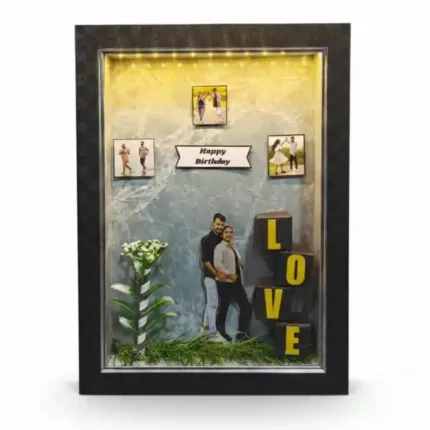 Top LEDs, premium black 3D shadow box frame. Couple cutout, mini hanging photos and 3D blocks spelling LOVE.
