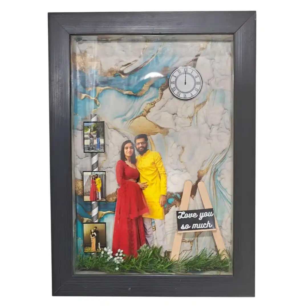 love-you-so-much-3d-miniature-frame-gif39 A deep 3D shadow box frame with a teal marble background, with a couple cutout, mini clock and a miniature wooden easel that says Love you so much.