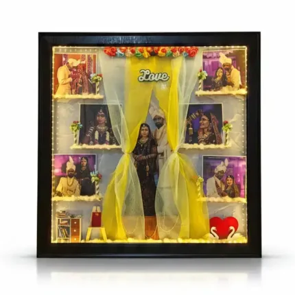 Beautifully lit 3D wedding shadow box frame with full LED border, traditional couple cutout, 6 mini photos, and a red heart swan figurine.