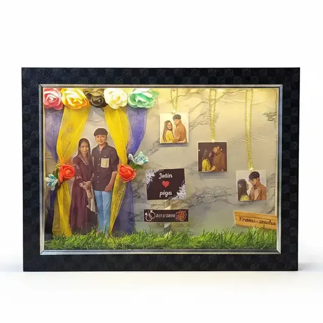 led-frame-promise-rings-gif46 A textured black 3D shadow box frame with a couple photo cutout under fabric curtains, custom nameplates and 3 photos hanging from gold chains.